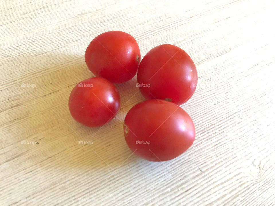 red tomatoes on wooden background