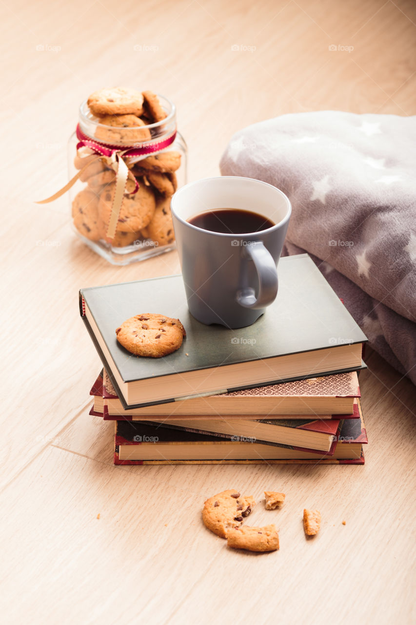 A few books with cup of coffee and cookies on wooden floor. Time for relax. Spending leisure time on reading. Cozy and comfortable. Relaxing 😌