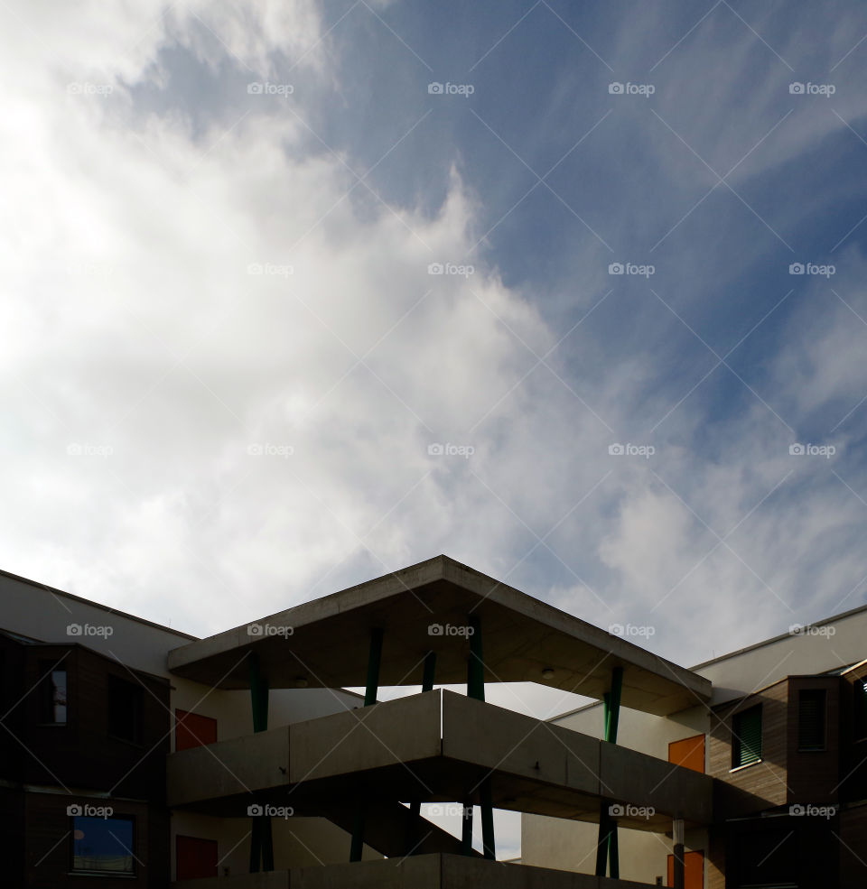 Low angle view of built structure in city against sky by day.