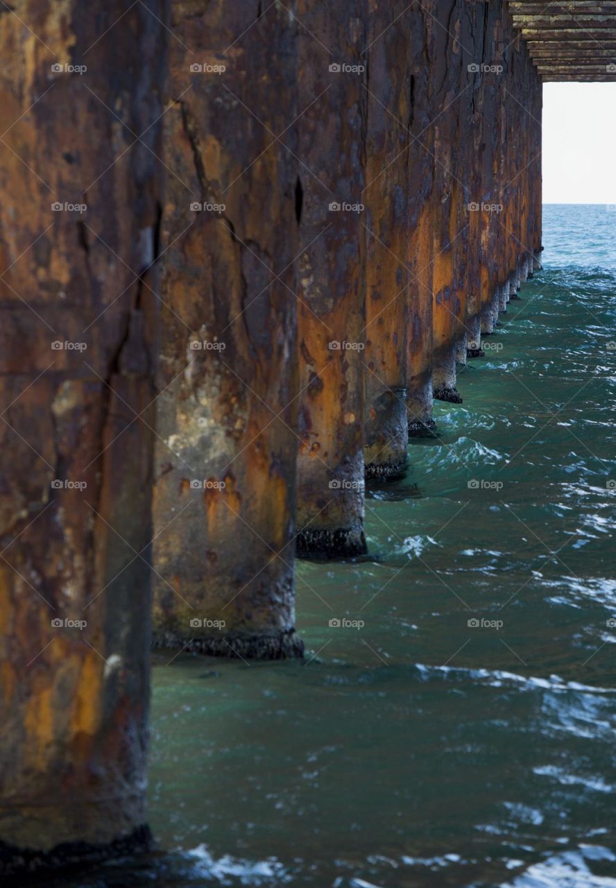 Rusty columns in the sea water