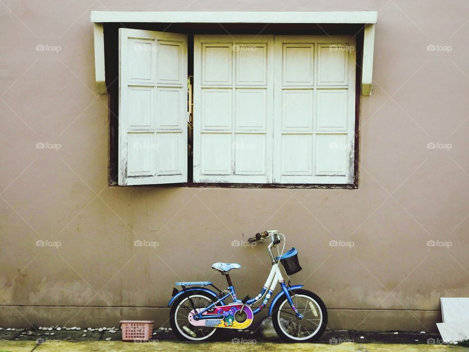Bicycle leaning on wall