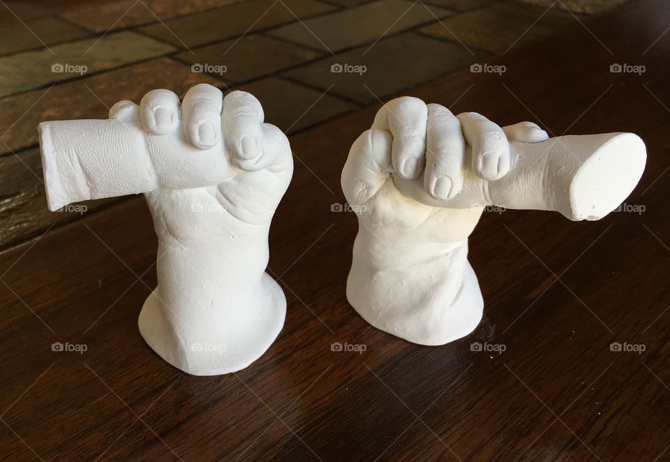 Newborn baby hand molds holding mom and dad’s fingers 