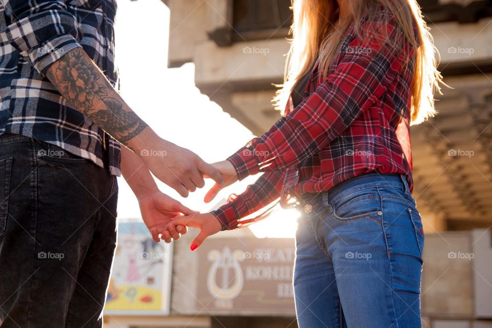 Couple in love holding hands at sunset