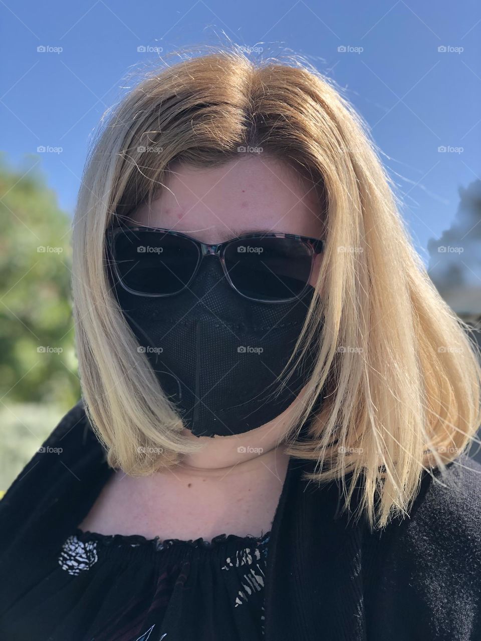 Mysterious Woman wearing mask and dark sunglasses reminds me of a Siamese cat