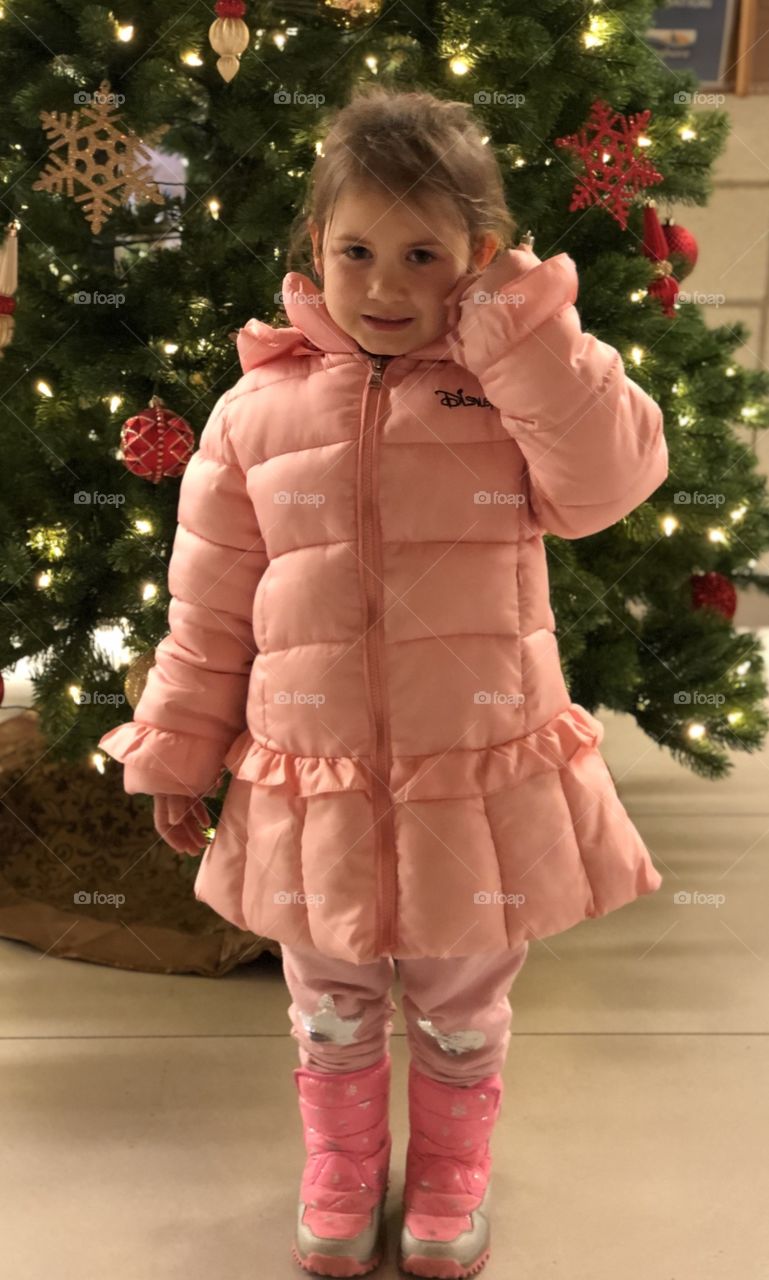 A little girl enjoying her Christmas Tree