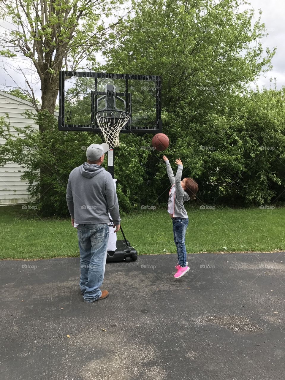Father and daughter playing basketball 