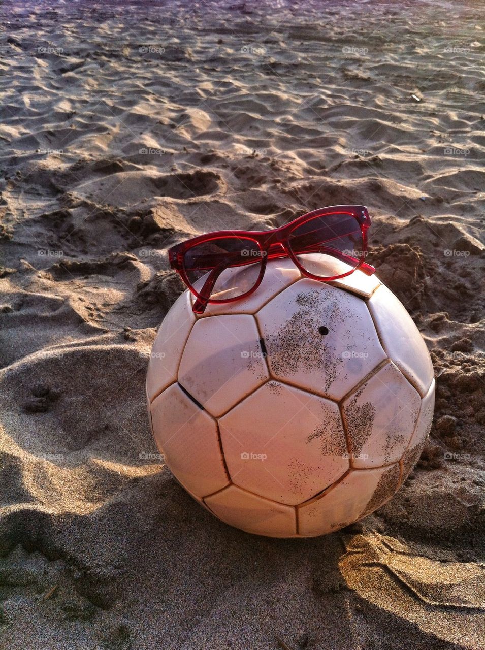 Shades, football, sun and sand