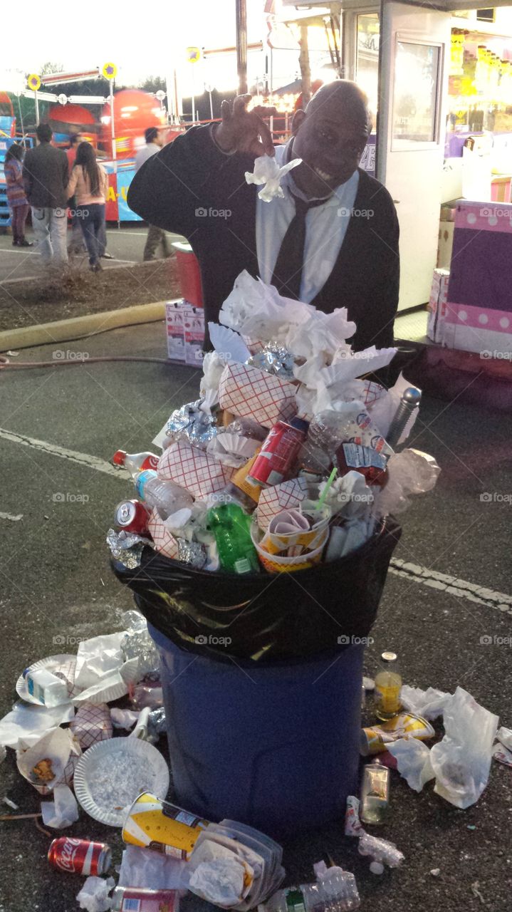 Adding to the pile. The garbage just kept building up at the carnival. Guess there was no cleanup crew.  