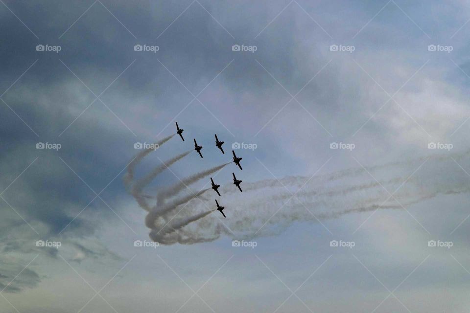 Silhouette of airplane airshow in sky