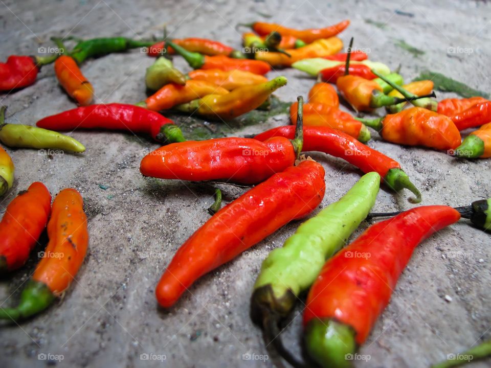 Close-up view of cayenne pepper scattered on the ground