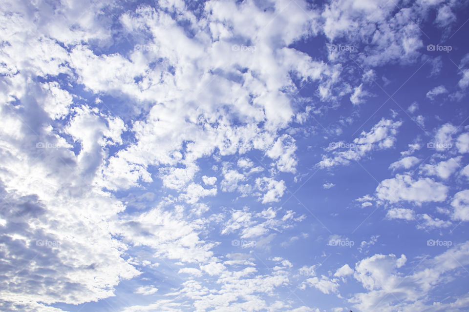 The beauty of the sky with clouds and the sun.