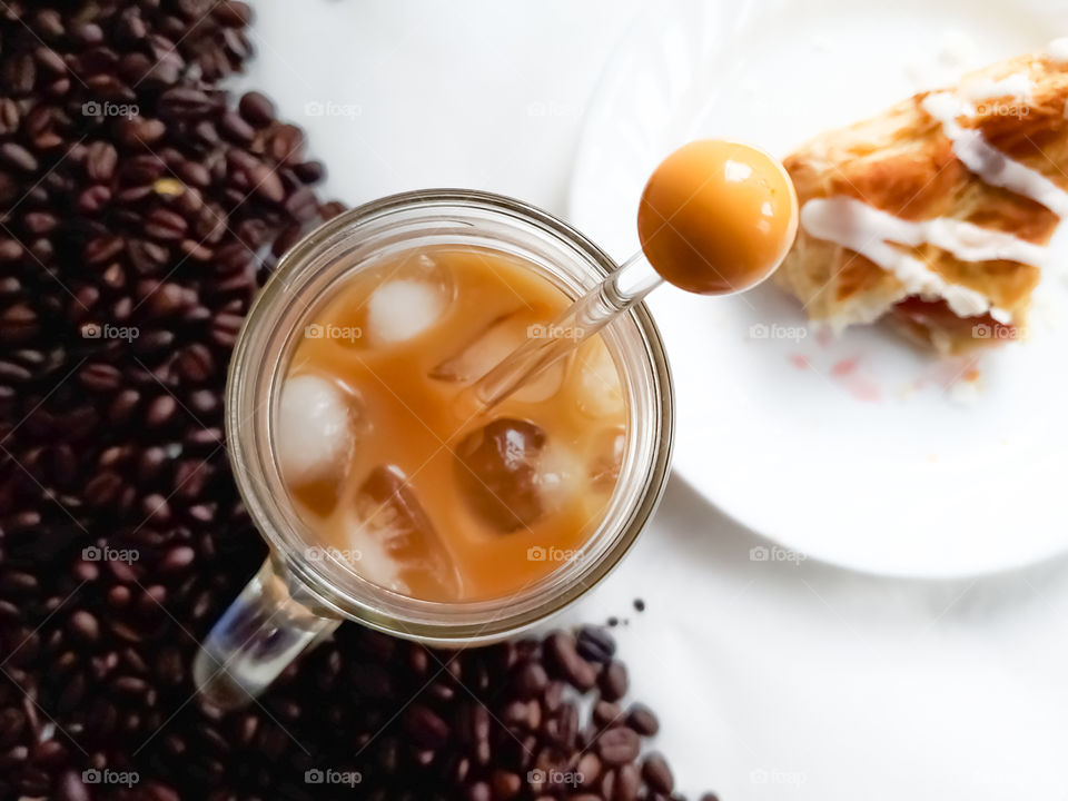 Iced coffee and a turnover pastry; a perfectly delicious pair .