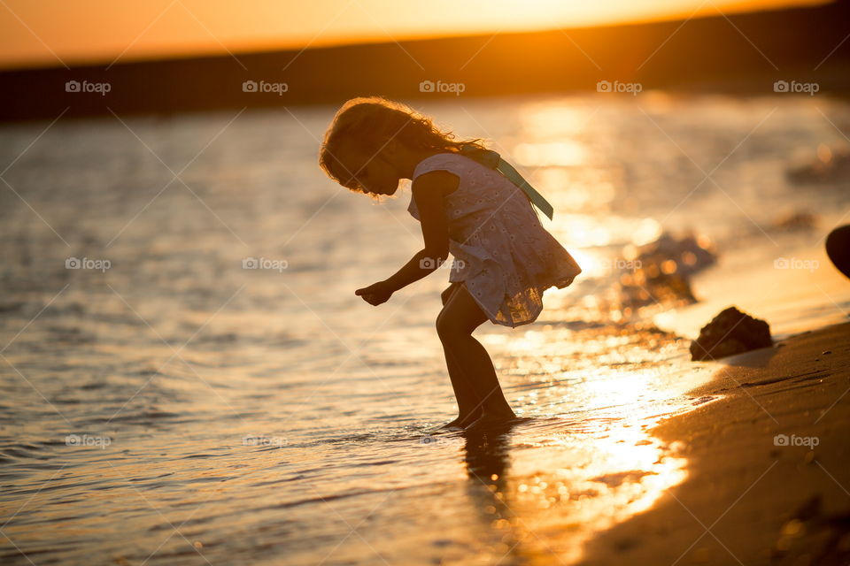 Little girl playing in the sea