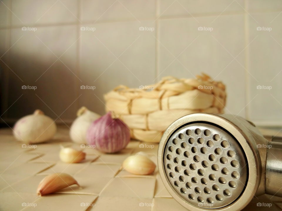 garlic and garlic squeezer in macro