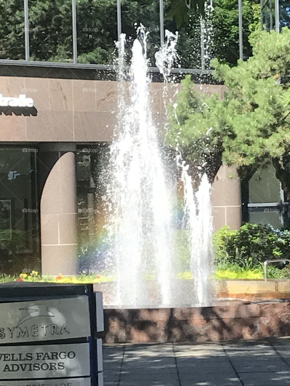 A fountain in Bellevue with the rainbow