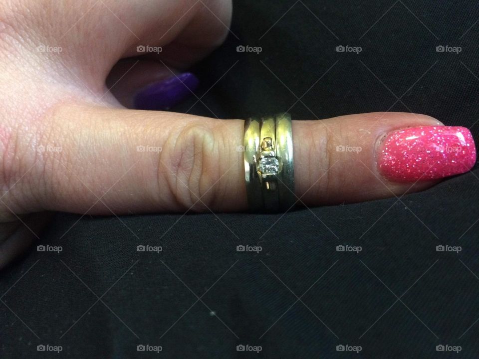 24 carat white gold, with diamond Wedding ring and 2-24 carat white gold wedding bands on either side, on my left hand, manicured gel nail painted pink pointer finger, because I was selling them because I got divorced