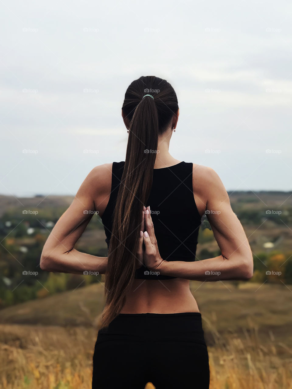 Young woman with long hair doing yoga outdoor 