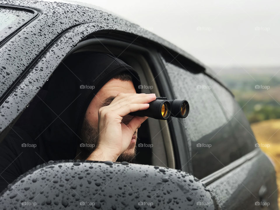 Looking through binoculars at road trip 