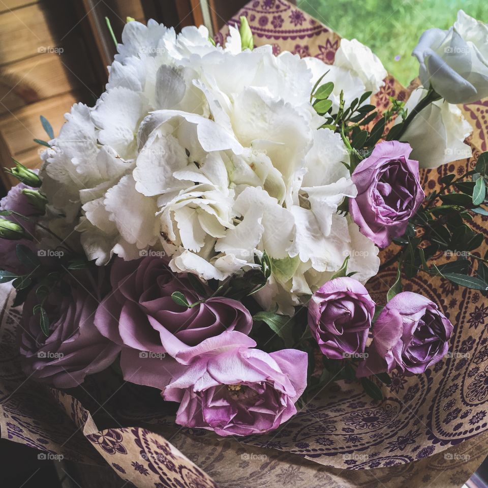 background gift gentle bouquet of beautiful white hydrangeas and purple roses, in the interior of a country house
