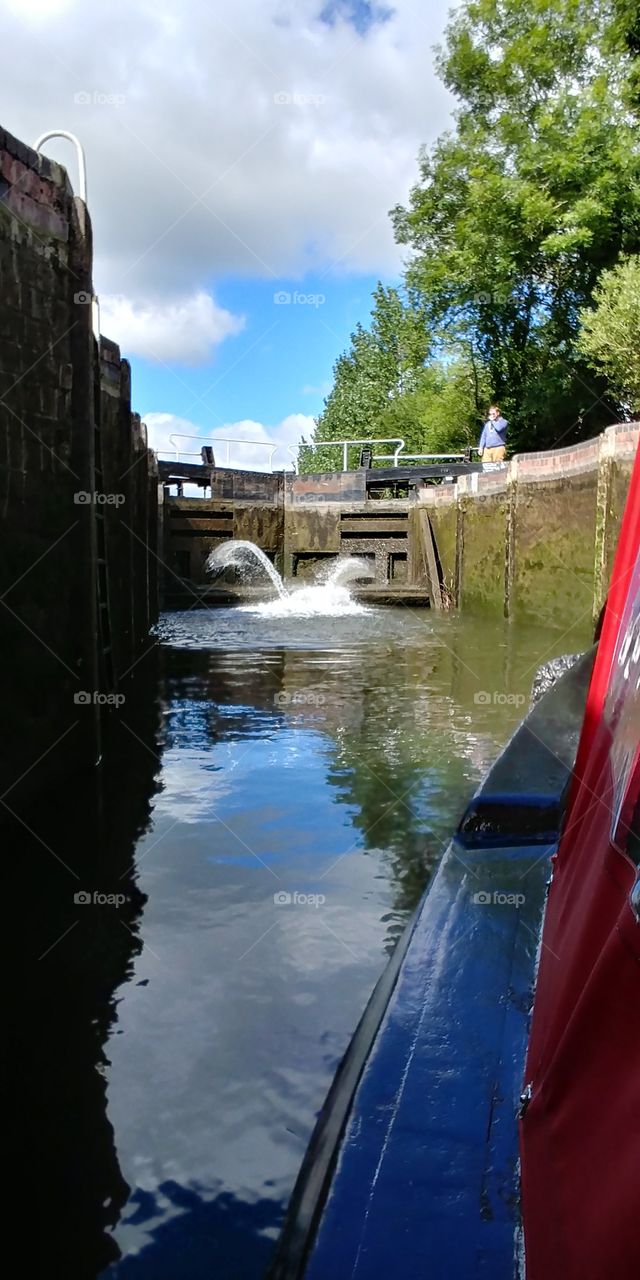 view of water flowing out of lock gate from canal boat