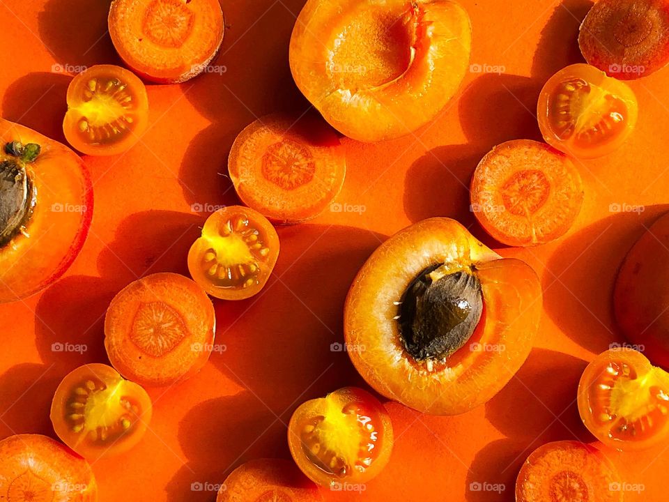 Orange fruit and veg in lines