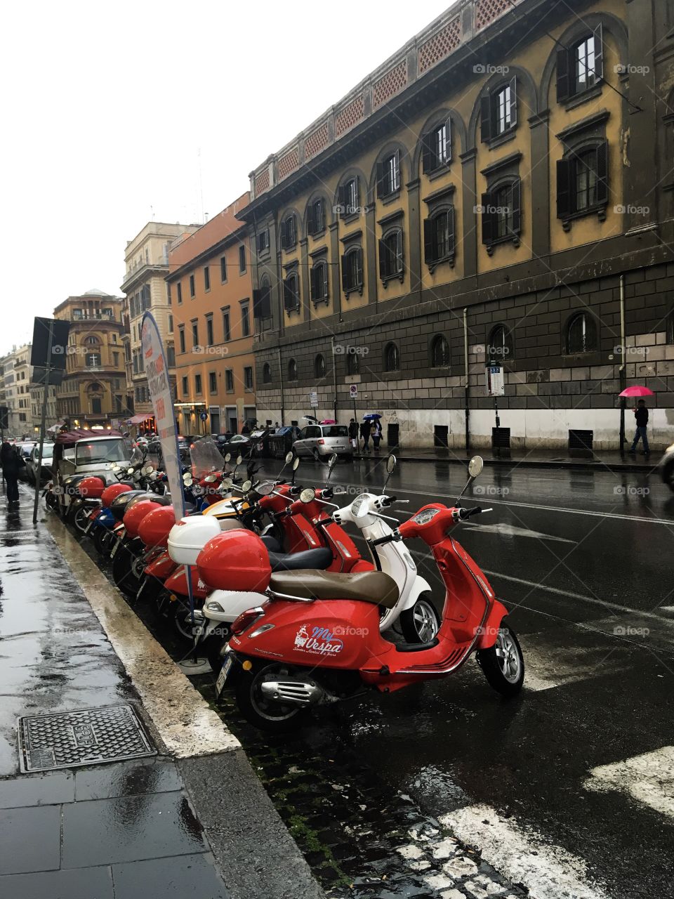 One of the street in Rome, Italy. Rainy day. Colorful scooters. 