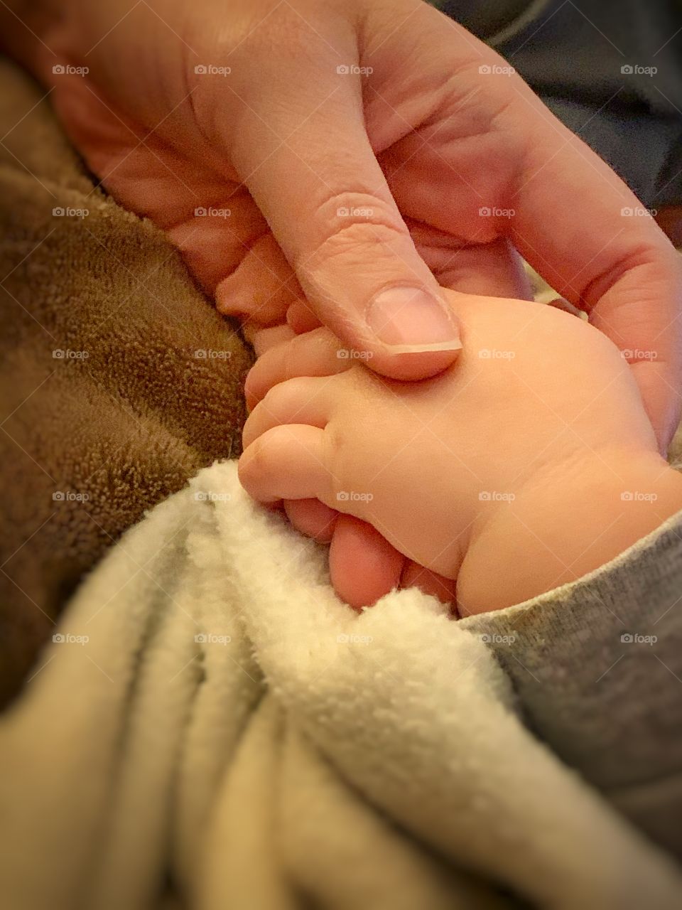 a warm picture of my wife holding our daughter’s hand on a relaxing night at home