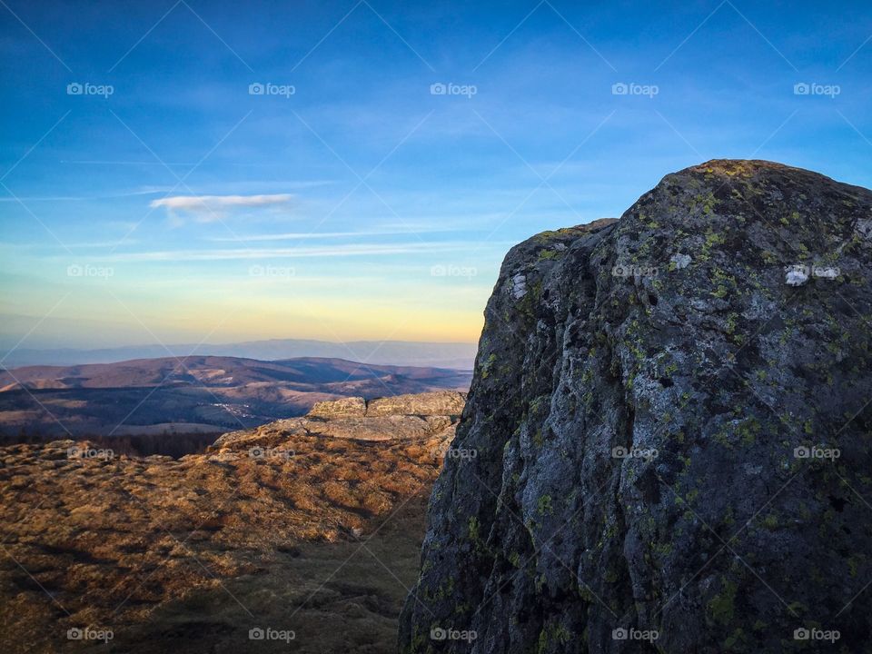 Scenic view of rocky mountains at sunset