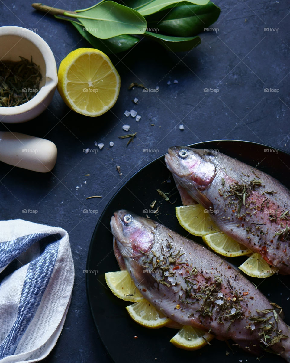 fish, lemon and spices prepared for cooking process
