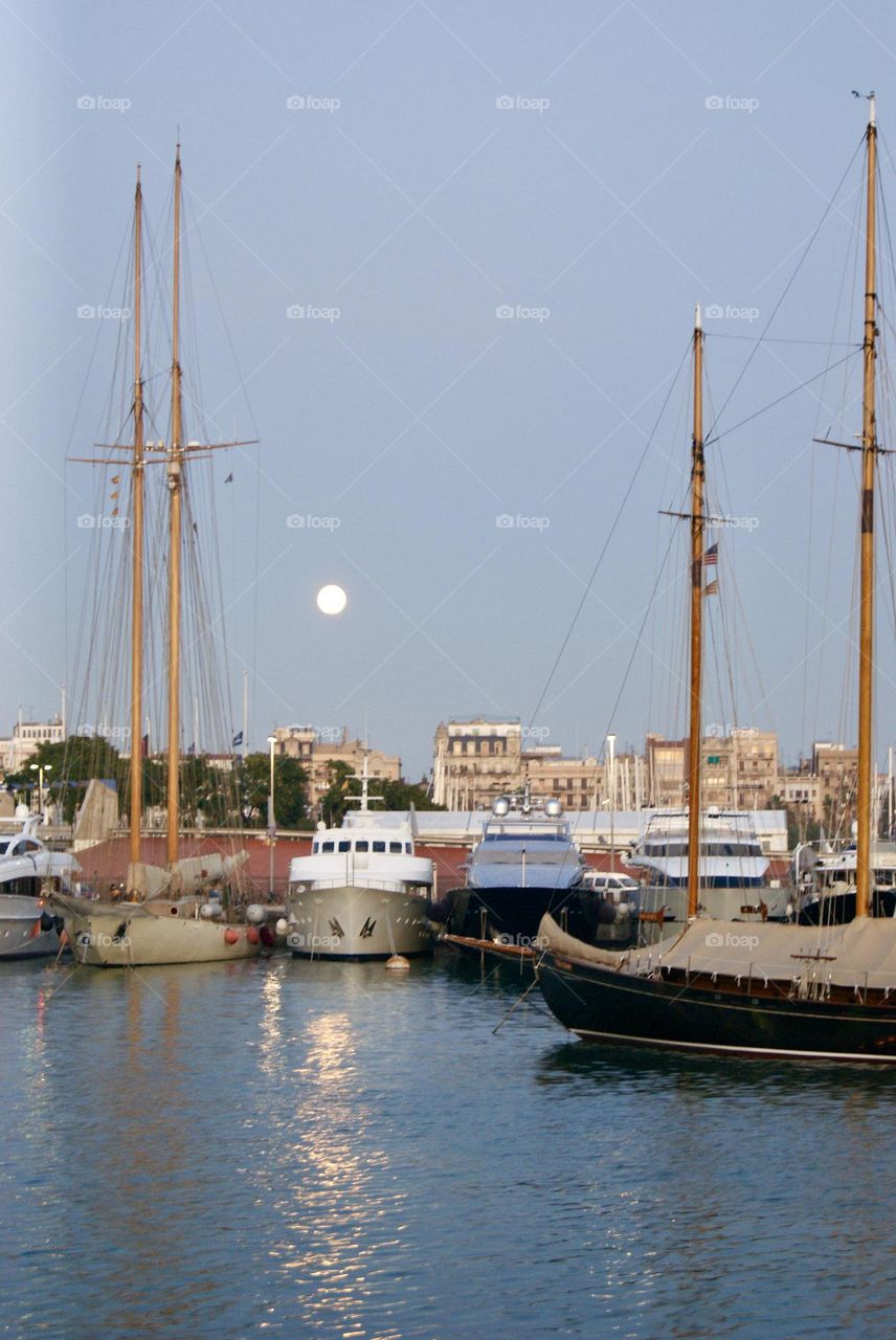 marina in the late afternoon with a full moon