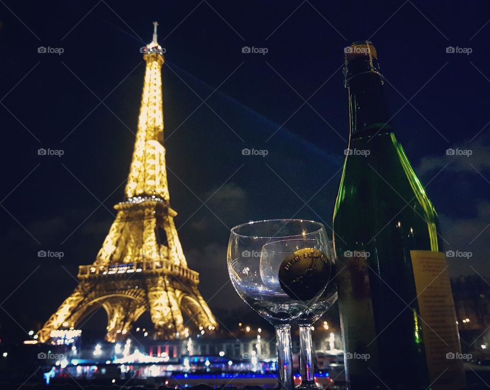 new years eve in the Eiffel tower with a bottle of champagne and glasses