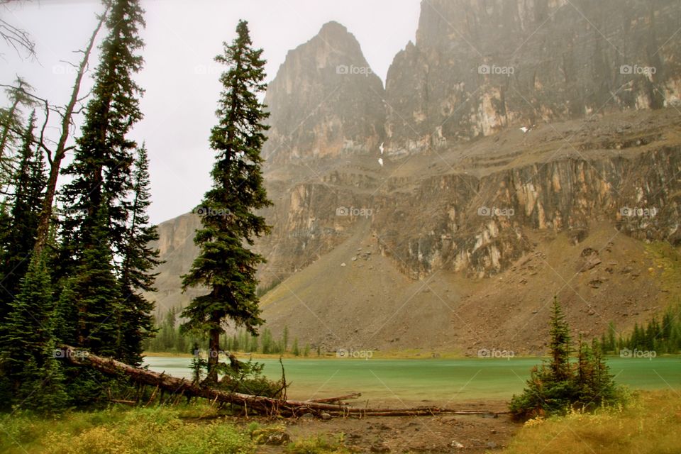 Mountain lake with the mountains overhead in the rain. Banff National Park, Alberta 