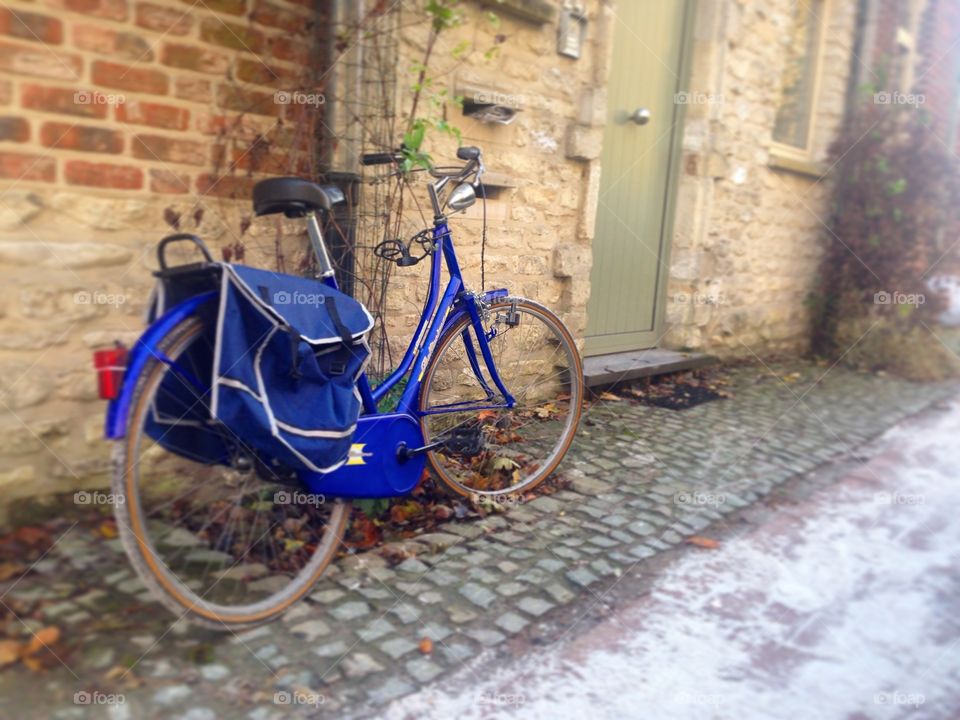 Blue bike in Brussels. A blue bike awaits it's owner's return. The scenery reflects typical Belgian atmosphere- cobblestone and charming homes.
