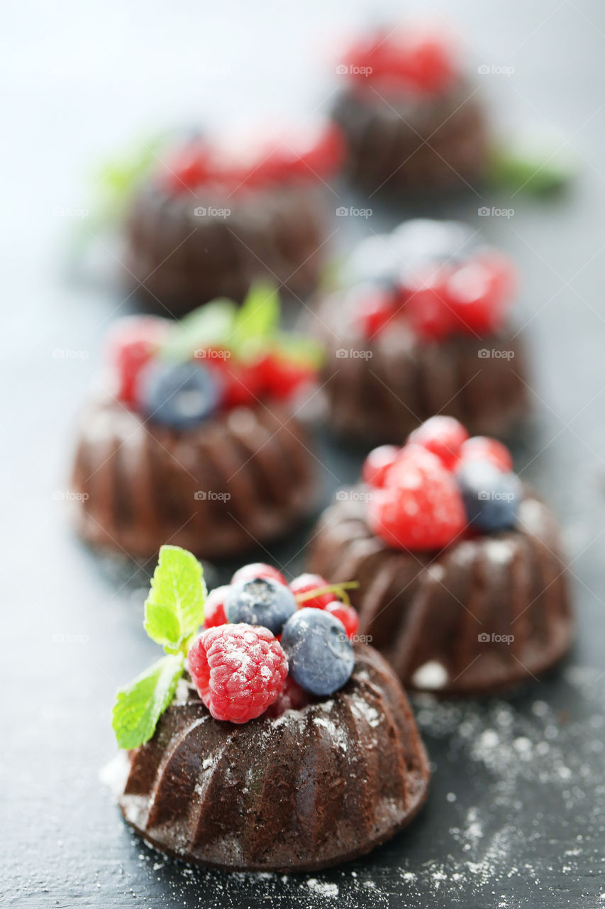 Chocolate cupcakes with berries. Summer