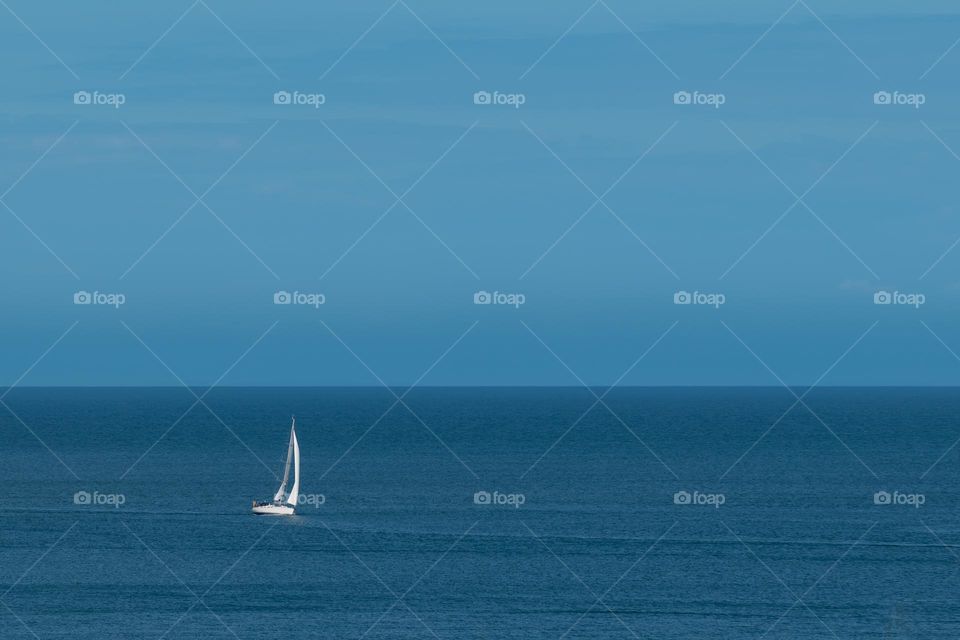 Yacht sailing in calm sea waters.