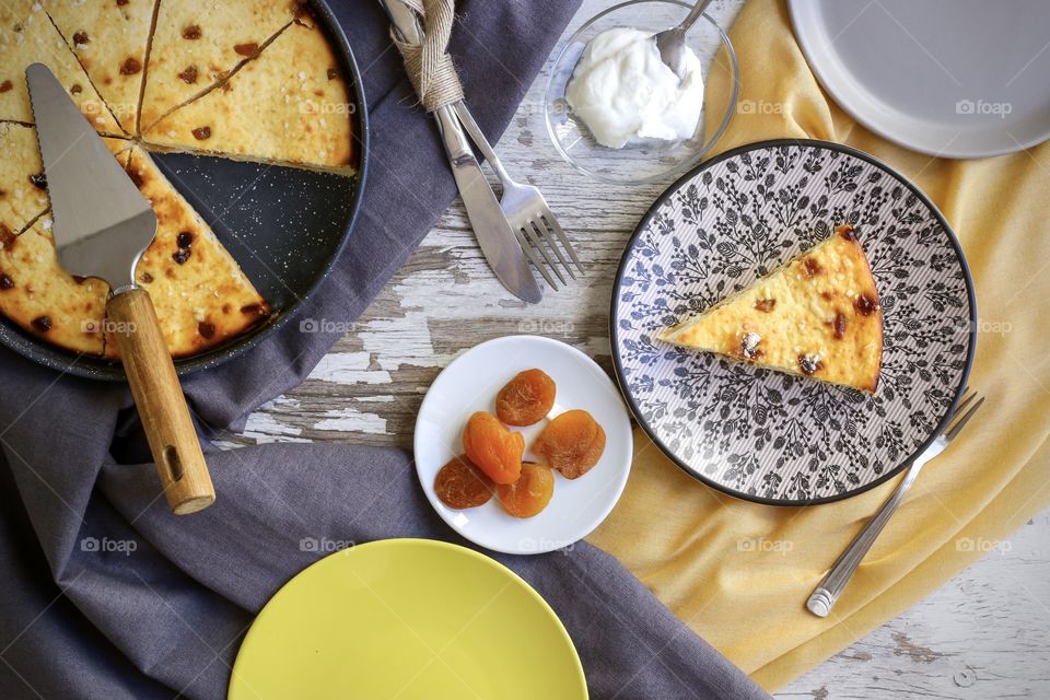 cottage cheese pie with dried apricots and yellow cloth