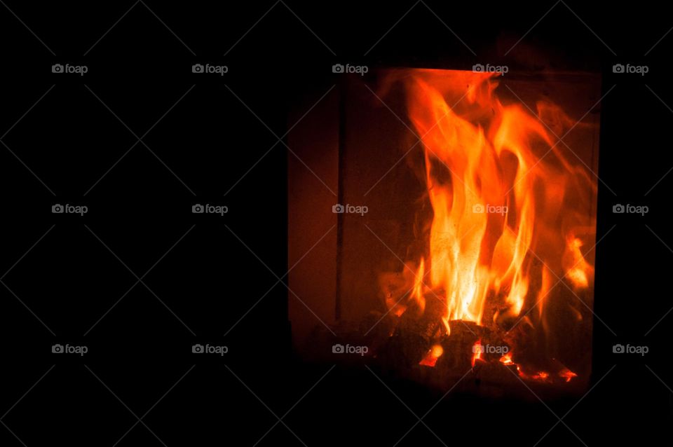 The fire is burning in the fireplace.  Heat supply. Heating