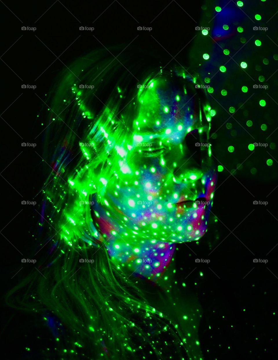 Girl lighted eith galaxy-light, green