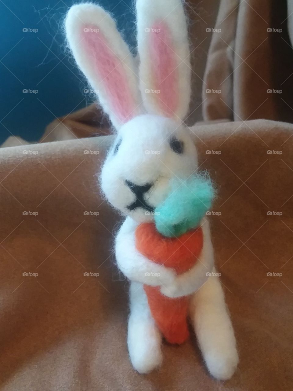 Cute needle felted white bunny with a carrot..