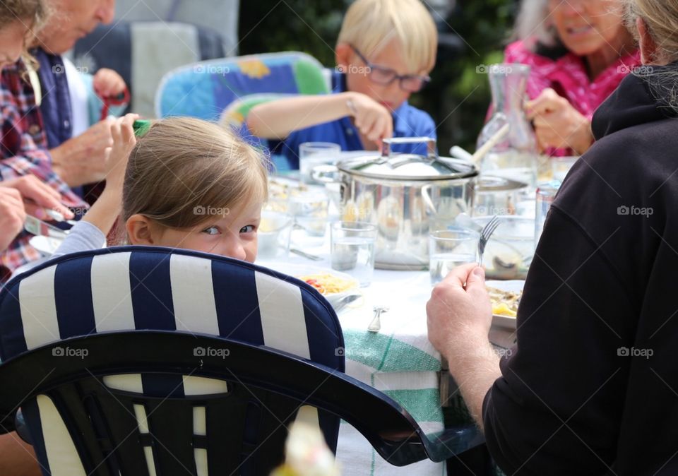 Girl enjoying dinner with her family