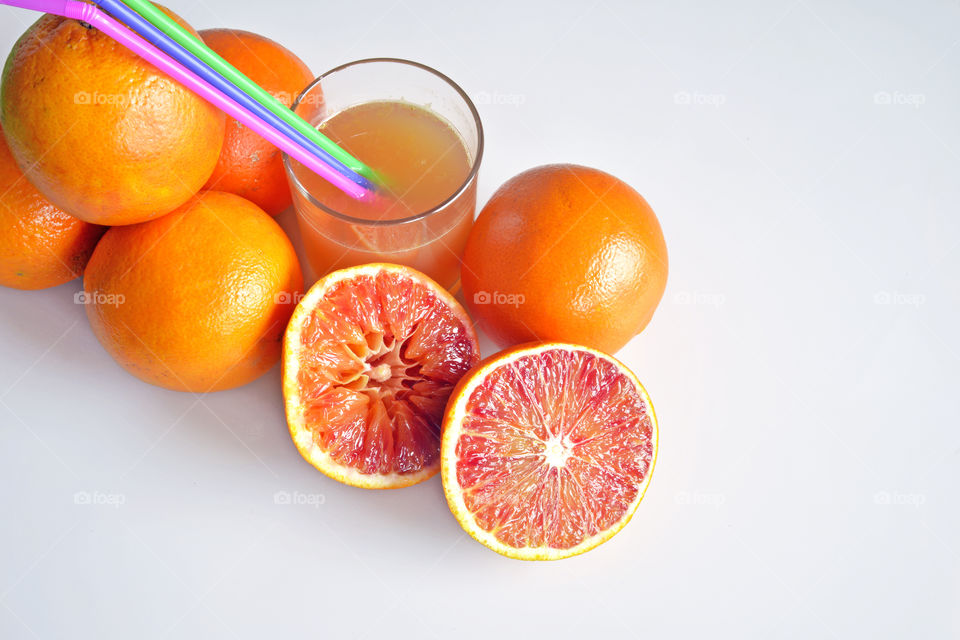 Glass of grapefruit with drinking straw