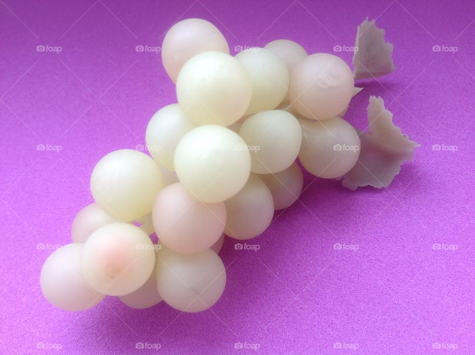 White grapes on a violet background