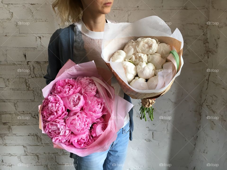 Girl with bunch of peonies 