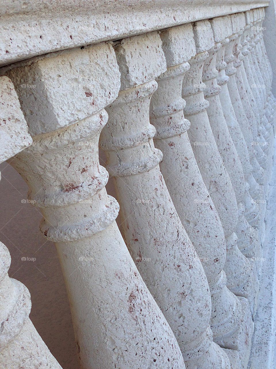 Repeating row of stone pillars.