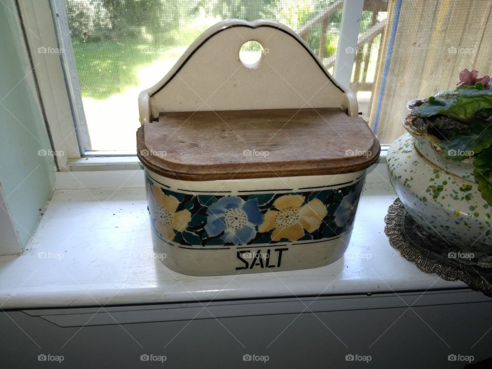 Salt box sitting in window sill