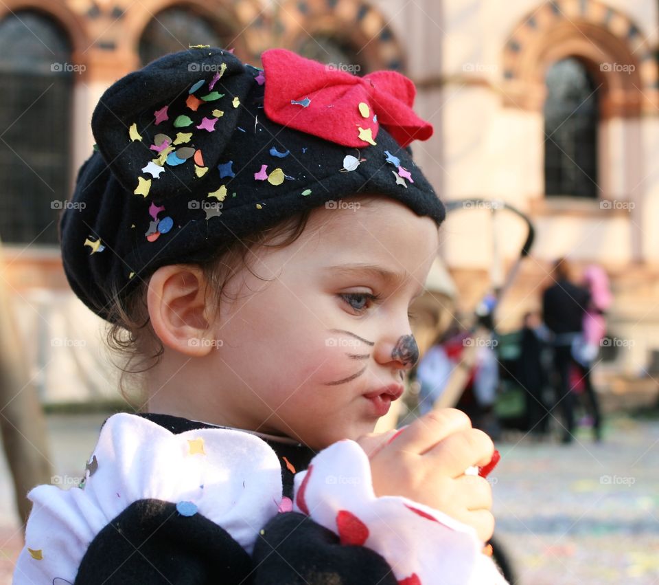 Close-up of a little girl in cat's costume