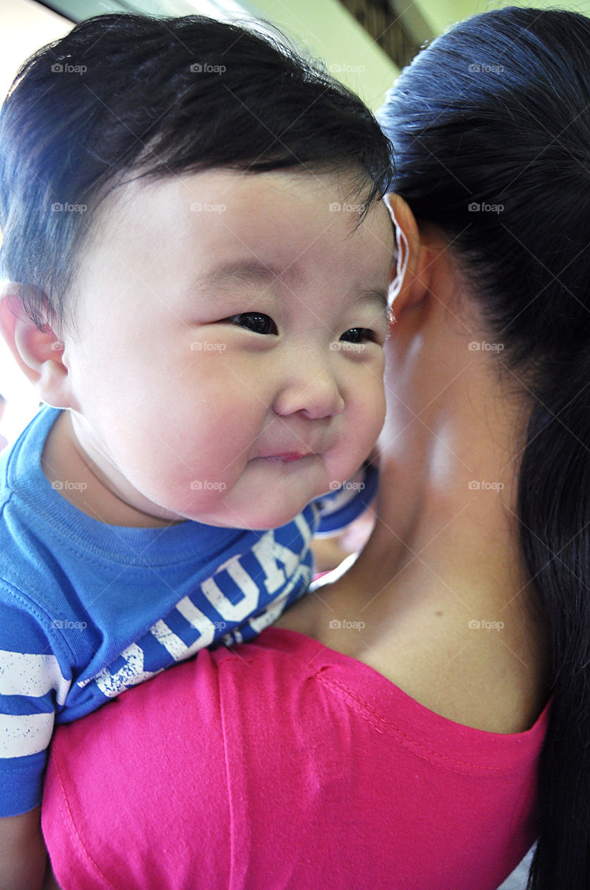 Close-up of a mother carrying her son