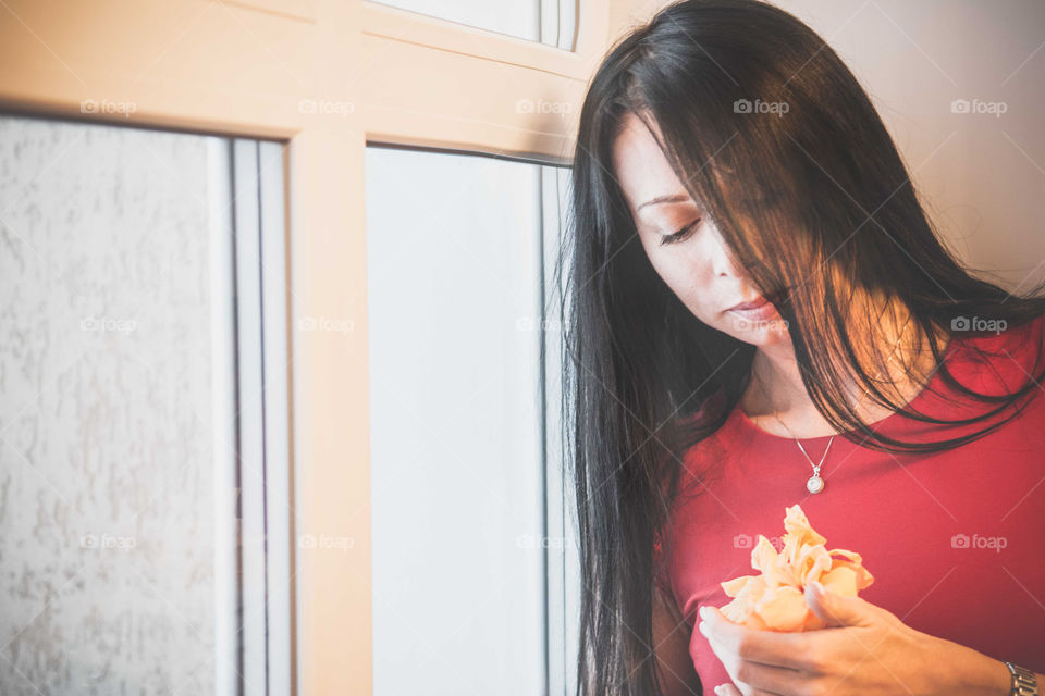 Close-up of a woman with flowers in hand