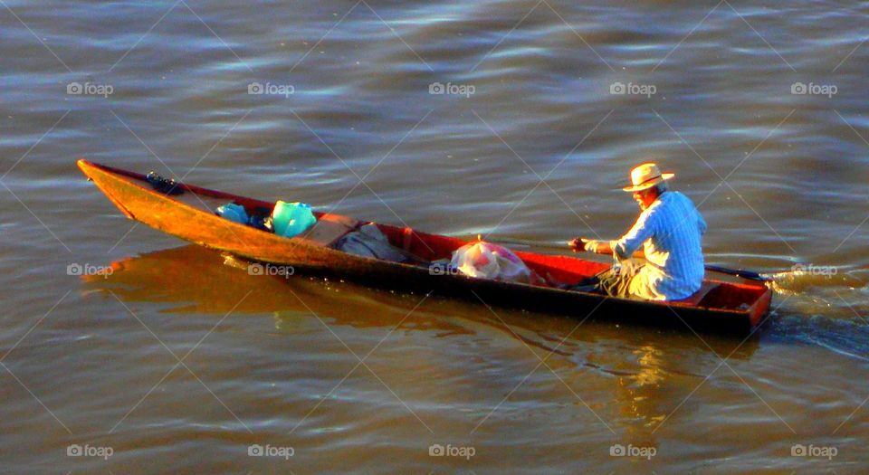 A man in a boat. A man in a boat alone