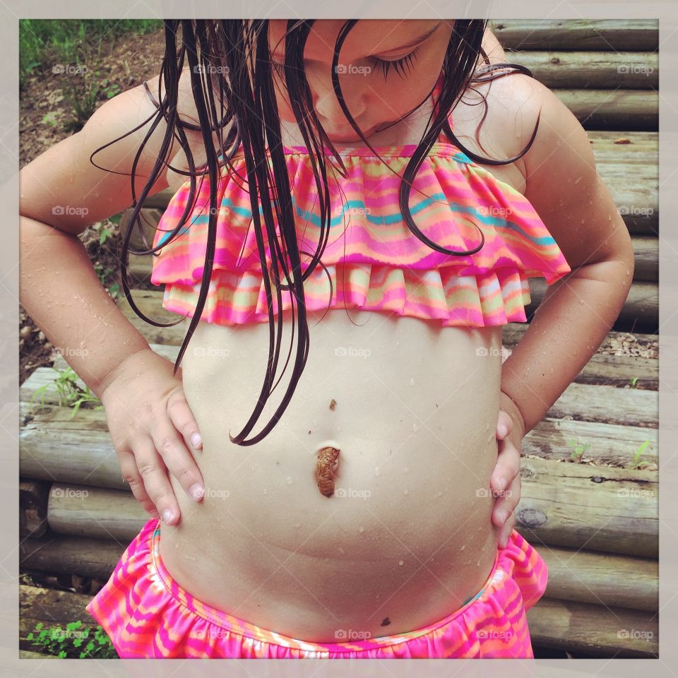 Close-up of insect on girl's stomach
